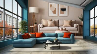 Domestic living room with a sofa, lamp, and minimal art frame with a beige color tone. Wall mural