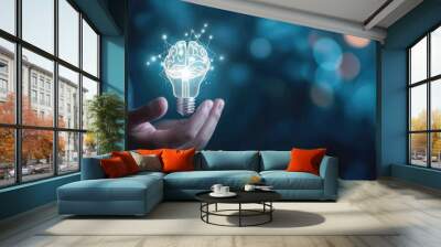 Businessman holding half of the virtual lightbulb and brain on blue bokeh background, Smart thinking idea and inspiration innovation concept  Wall mural