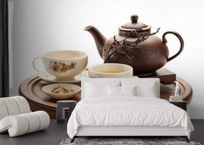 Isolated on white there is a Chinese teapot and teacups with a wooden trivet on white background Wall mural