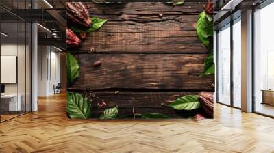 Top view of cocoa pods and green leaves on wooden background with space for text Wall mural