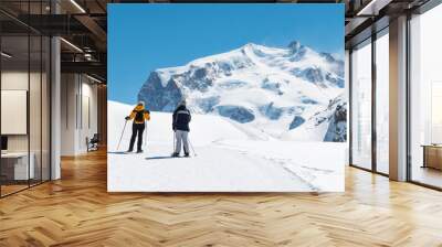 two people are trekking on the snow mountain Wall mural