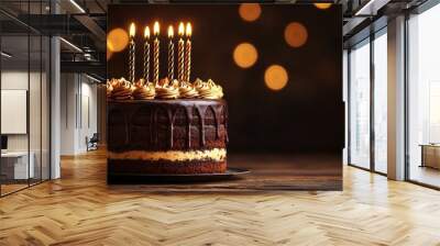 A delicious chocolate birthday cake with lit candles against a bokeh background. Perfect for celebrating sweet moments and special occasions. Wall mural