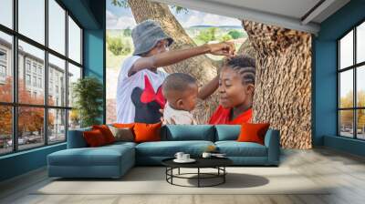 village african family mother with braids holding the child teenager playing with her hair Wall mural