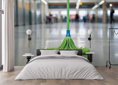 A mop on a shiny, reflective floor in a blurred indoor setting, suggesting a clean and well-maintained public space like an airport or train station Wall mural