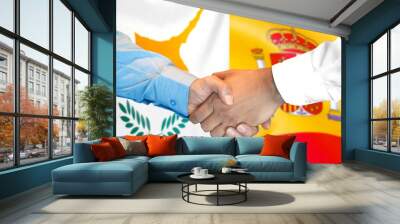 Business handshake on the background of two flags. Men handshake on the background of the Cyprus and Spain flag. Support concept Wall mural