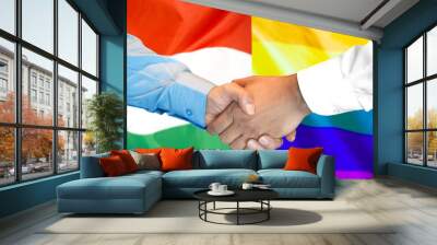 business handshake on the background of two flags. men handshake on the background of the hungary an Wall mural