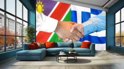 Business handshake on the background of two flags. Men handshake on the background of the Namibia and Greece flag. Support concept Wall mural