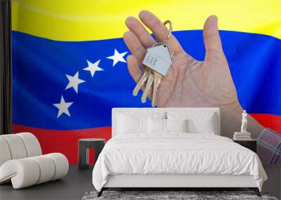 Hand shows the keys to the apartment on background of flag Venezuela. Keys to the apartment in a female hand on background of flag Venezuela. Realty concept new apartment in Venezuela Wall mural