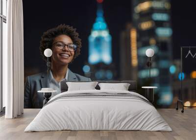 Portrait of happy African American woman is smiling and looking at the camera on background of night city with copy space Wall mural