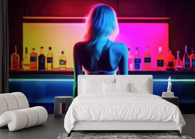 Single girl in a bar going out alone in the moody nightlife in dim light Wall mural