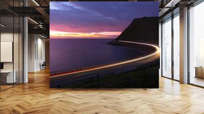 car lights at dusk on the road next to the coast of zumaia, gipuzkoa, euskadi Wall mural