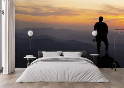 man on top at sunset surrounded by mountains Wall mural