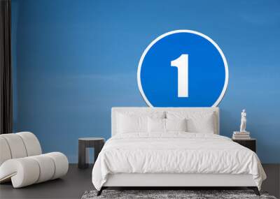 '1 (one)' sign in blue round frame. Clear sky is on background Wall mural