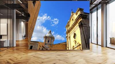 little square with old classical colorful buildings, church dome and cloudy blue sky in coastal town Licata in Sicily, Italy Wall mural