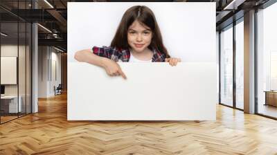 little cute girl points to an blank white board, space for text advertising, educational, advertising concept Wall mural