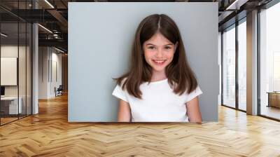 Portrait of a beautiful young girl in a white T-shirt on a gray background, concept advertising Wall mural