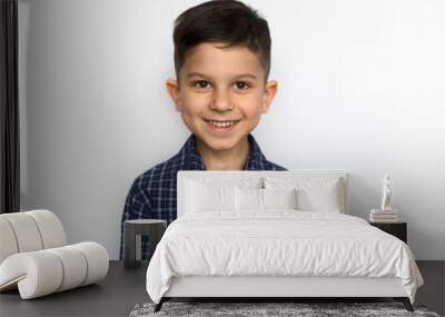 portrait of a cute little smiling boy in a blue shirt, isolated on a white background Wall mural