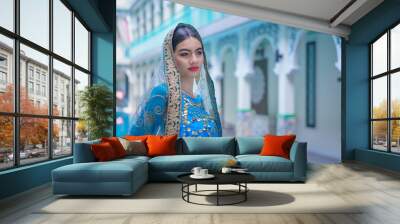 Beautiful fashionable Indian woman wearing Hindu Bride in a saree dress a traditional costume. Wall mural