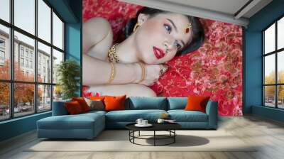 Beautiful portrait of young Asian woman in traditional Hindu red sari wedding clothes with bride dressed makeup and jewelery gorgeous brunette bride. Concept Indian costume Wall mural