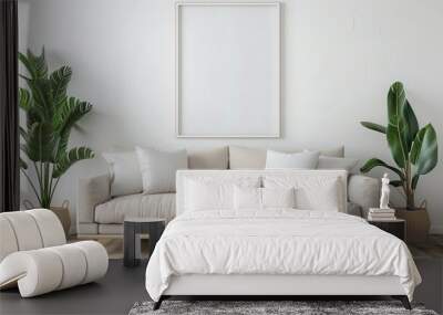 Modern living room interior with beige sofa, white pillows, two plants in woven baskets and a blank frame on a white wall. Wall mural