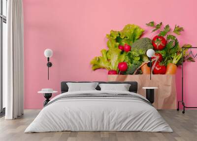 Healthy food in a paper bag on pink background Wall mural