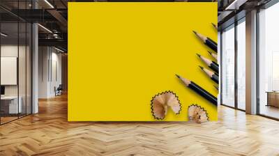 black pencils placed on yellow paper background with copy space for your image or text. Wall mural