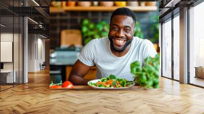 happy young black man holding salad. healthy eating. vegetable salad Wall mural