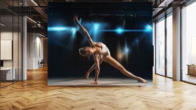 Ballerina posing on stage against spotlights Wall mural