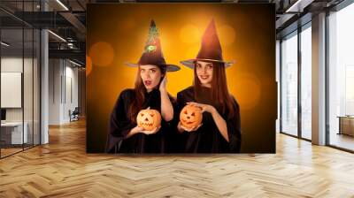 pretty young girls with pumpkins in hands Wall mural