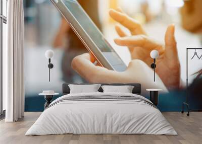 Closeup image of woman's hands holding and touching a smartphone Wall mural