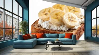 A slice of whole grain bread topped with creamy ricotta cheese and fresh banana slices, placed on a white background. Wall mural