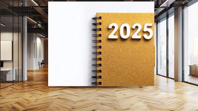 Golden notebook with the year 2025 and a pen, white isolate background. Wall mural