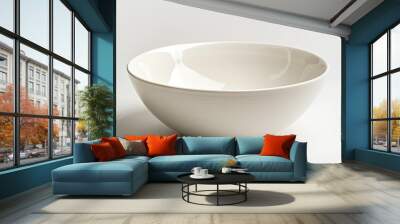 A large orange bowl sits on a white background Wall mural