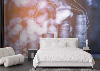 Double exposure of stacks of coins on the table in garden with financial graph chart, finance and business concept. Wall mural