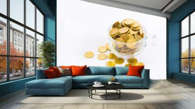 Golden coins in a glass of coffee, on the white background. Wall mural