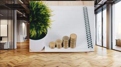 Step of coins stacks and alarm clock, notebook and financial graph, business planning vision and finance analysis concept. Wall mural