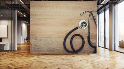 stethoscope with blue tube on wood table top view with copy space. health and medical concept. vinta Wall mural