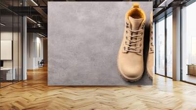 Stylish beige boots perfect for adventure and everyday wear on urban streets and trails Wall mural