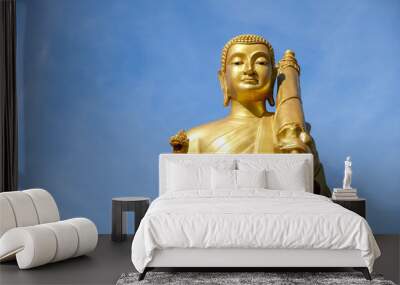 Golden Buddha statue on a clear sky background Wall mural