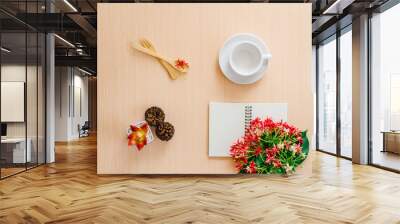 Cup of coffee , notebook, spoon and red pink flower on the wooden table with copy space. Wall mural