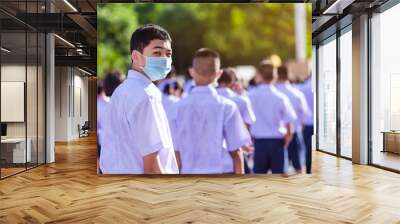 Asian male high school student in white uniform on the semester start wearing masks during the Coronavirus 2019 (Covid-19) epidemic. Wall mural