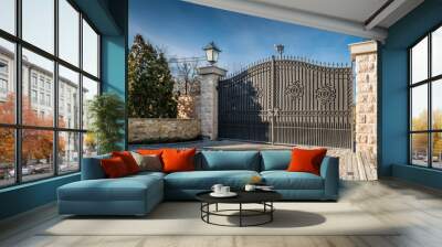 Metal driveway security entrance gates set in brick fence Wall mural