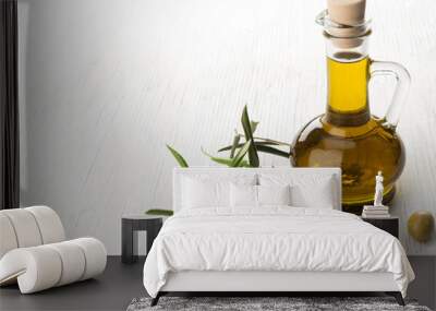 Olive oil and olive branch on the wooden table Wall mural