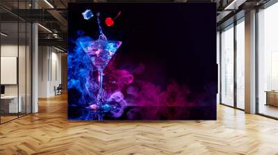 martini cocktail splashing in blue and purple smoky background Wall mural