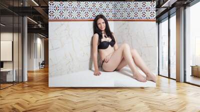 Beautiful girl sitting in a sauna Wall mural