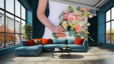 Beautiful wedding bouquet in hands of the bride Wall mural