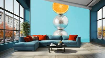 Creative vertical composition with three halved silver metallic orange fruits against pastel background. Minimal retro futurism fruit composition. Wall mural