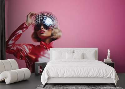 Girl in a shiny glittery pink suit holding a disco ball with a minimal background with copy space. It's party time. Retro style poster. Generative AI. Wall mural