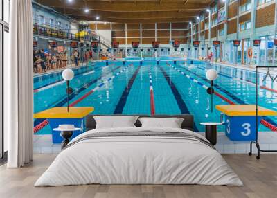 Indoor public swimming pool. Platforms for diving. No people swimming. High quality photo Wall mural