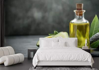 Bottle with essential oil and ripe fresh avocados on black background Wall mural